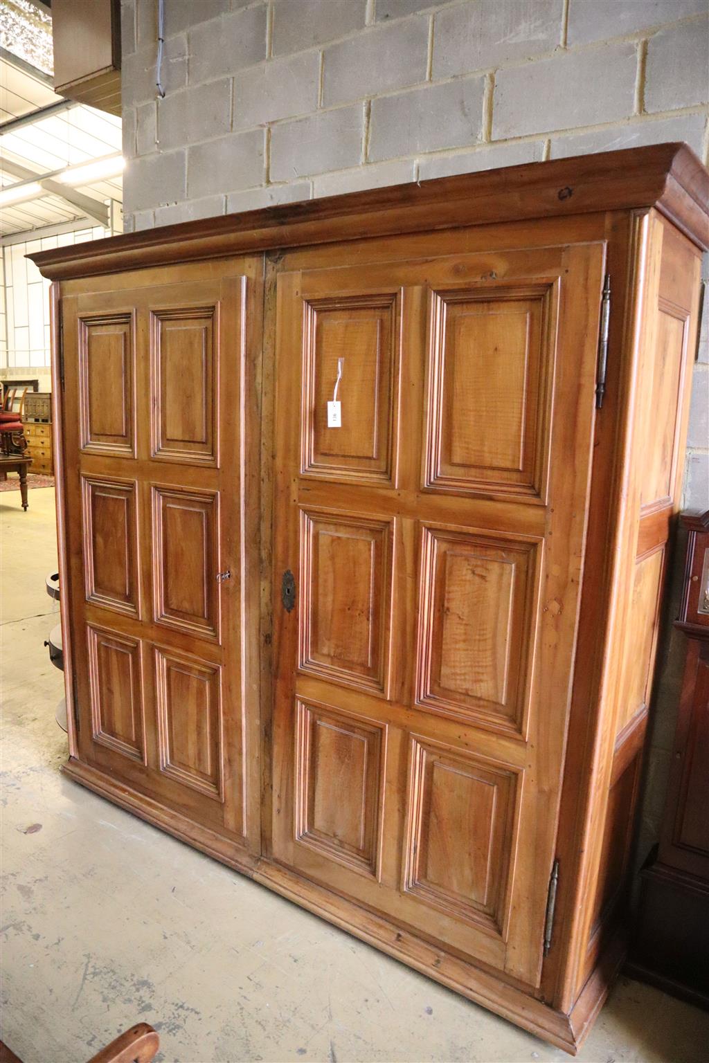 A 19th century French walnut two door panelled armoire, width 224cm, depth 58cm, height 222cm